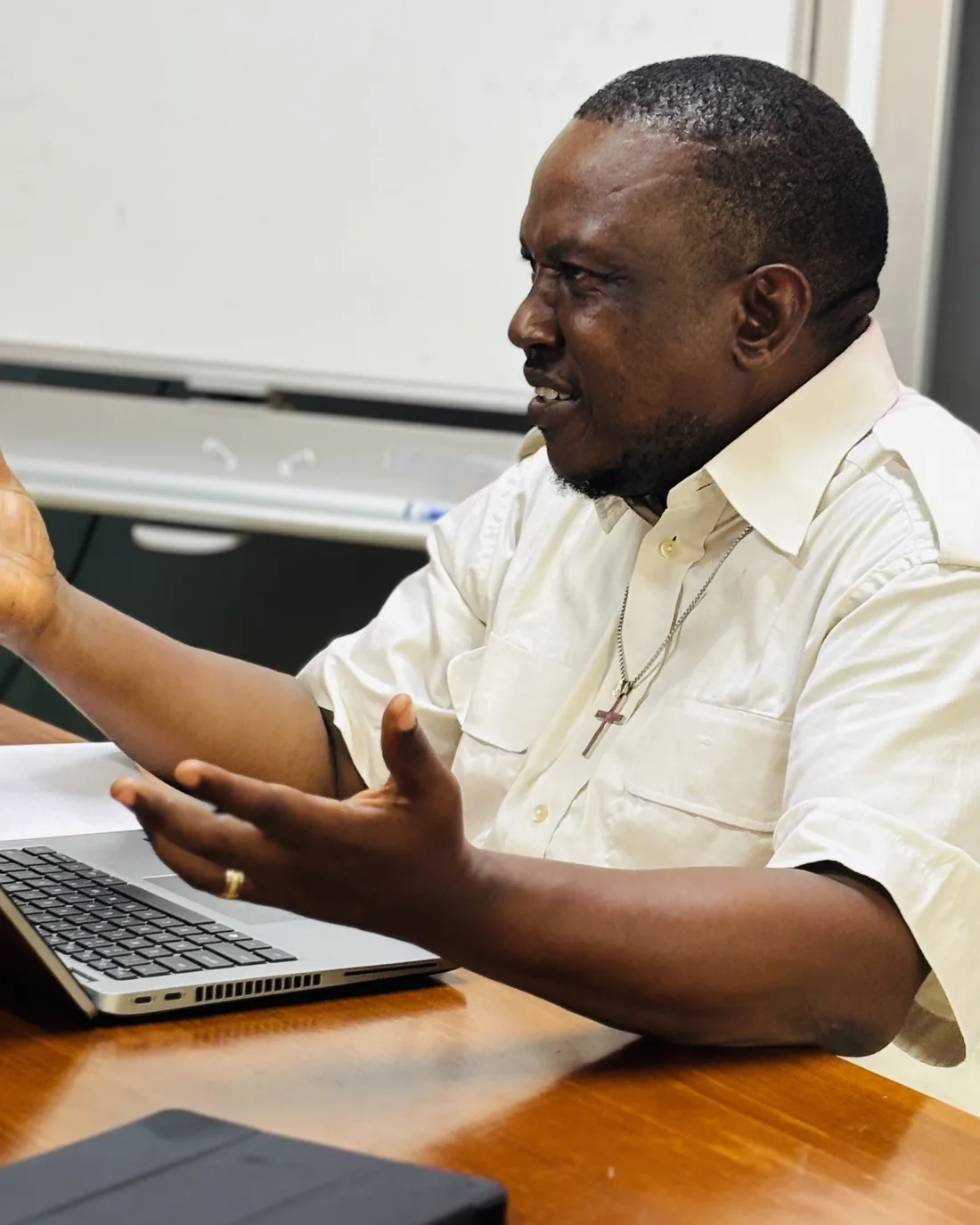 Anthony Nkumbe explaining a point at a laptop during a working session